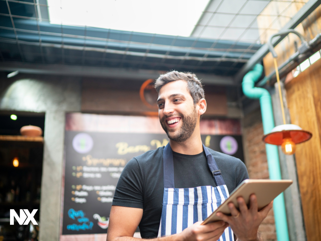Restaurant manager writing a shift log note on a tablet after service